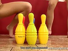 Teens have fun a game of bowling with piss