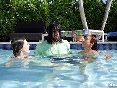 Horny black dude fucks two mischievous babes by the pool