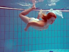 Cute redhead plays naked underwater