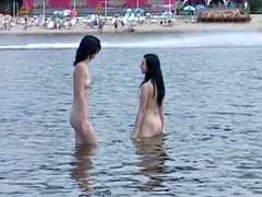 Two skinny nudist teens frolic around the beach