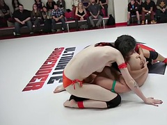 Black and white lesbian wrestlers wrestling in public