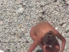 Bare femmes are luving on the beach while a naughty dude is taking pics of them