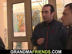 Old woman in red lingerie swallows two dicks