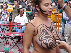 Latina gets bodypaint on her giant milk cans