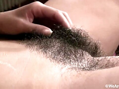 Sophie Moone Meticulously Grooms Her Furry Pussy in Bed