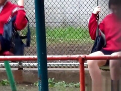 Asian pees on park bench