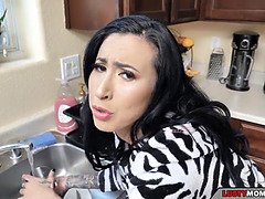 Son pounds his mom while she's washing the dishes